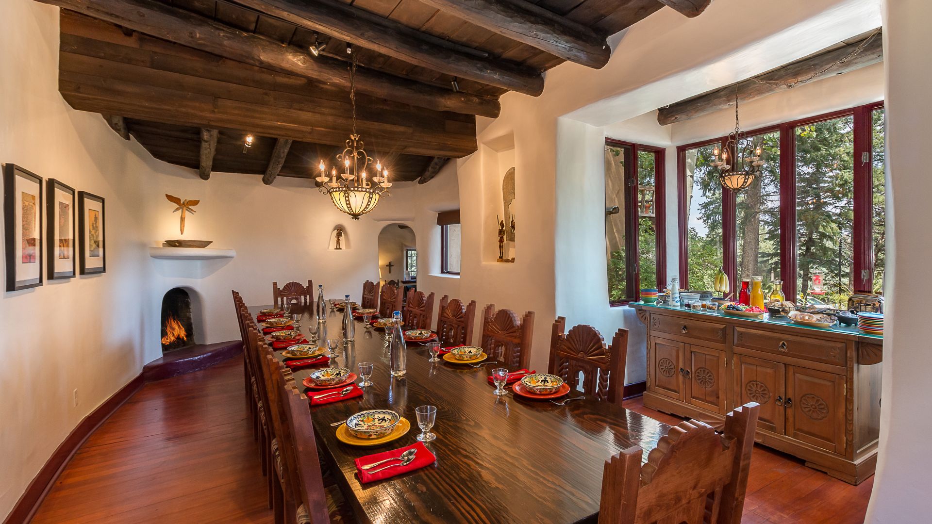 a long wood table is set for breakfast at inn of the turquoise bear