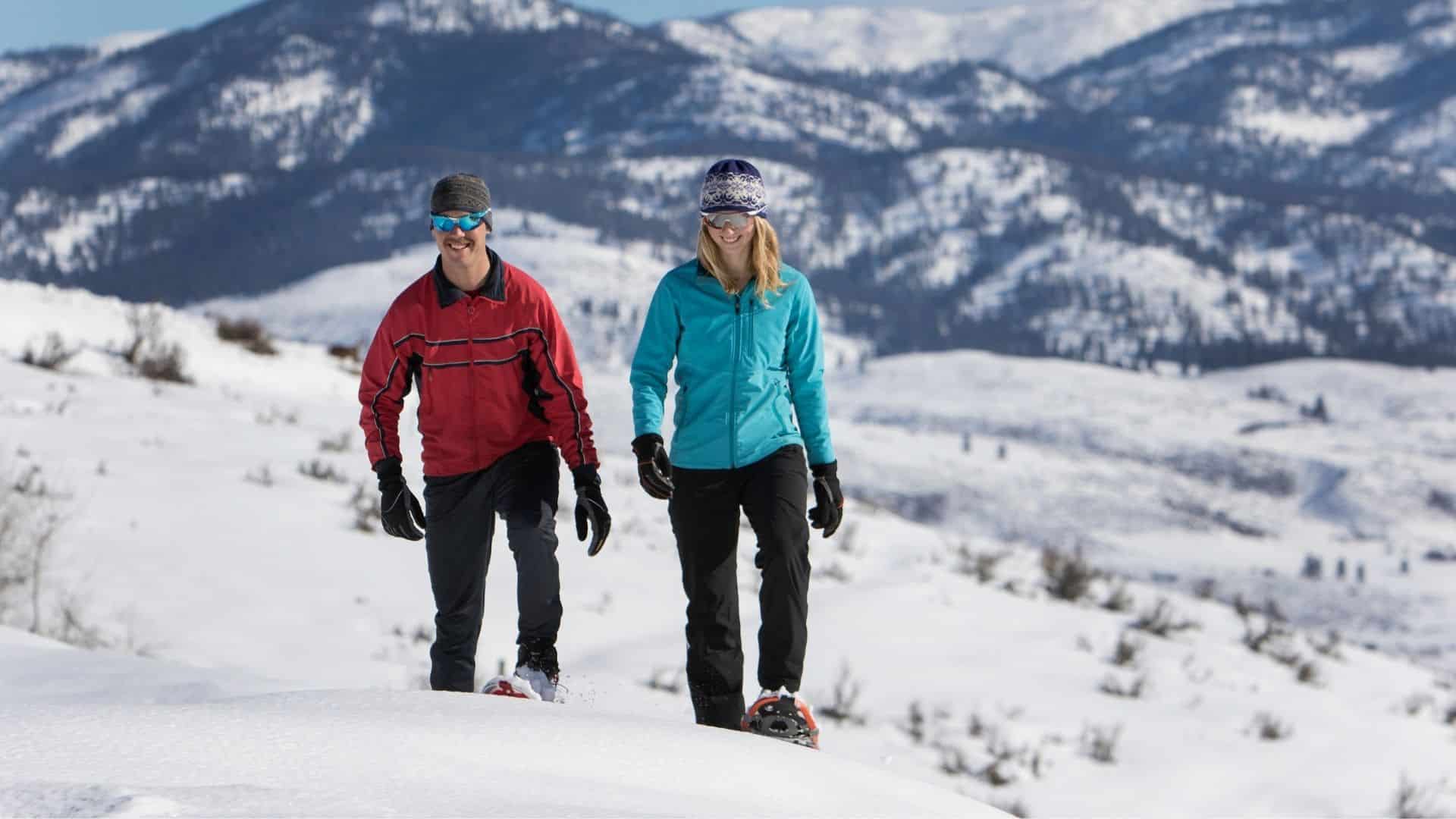 a couple having fun while snowshoeing